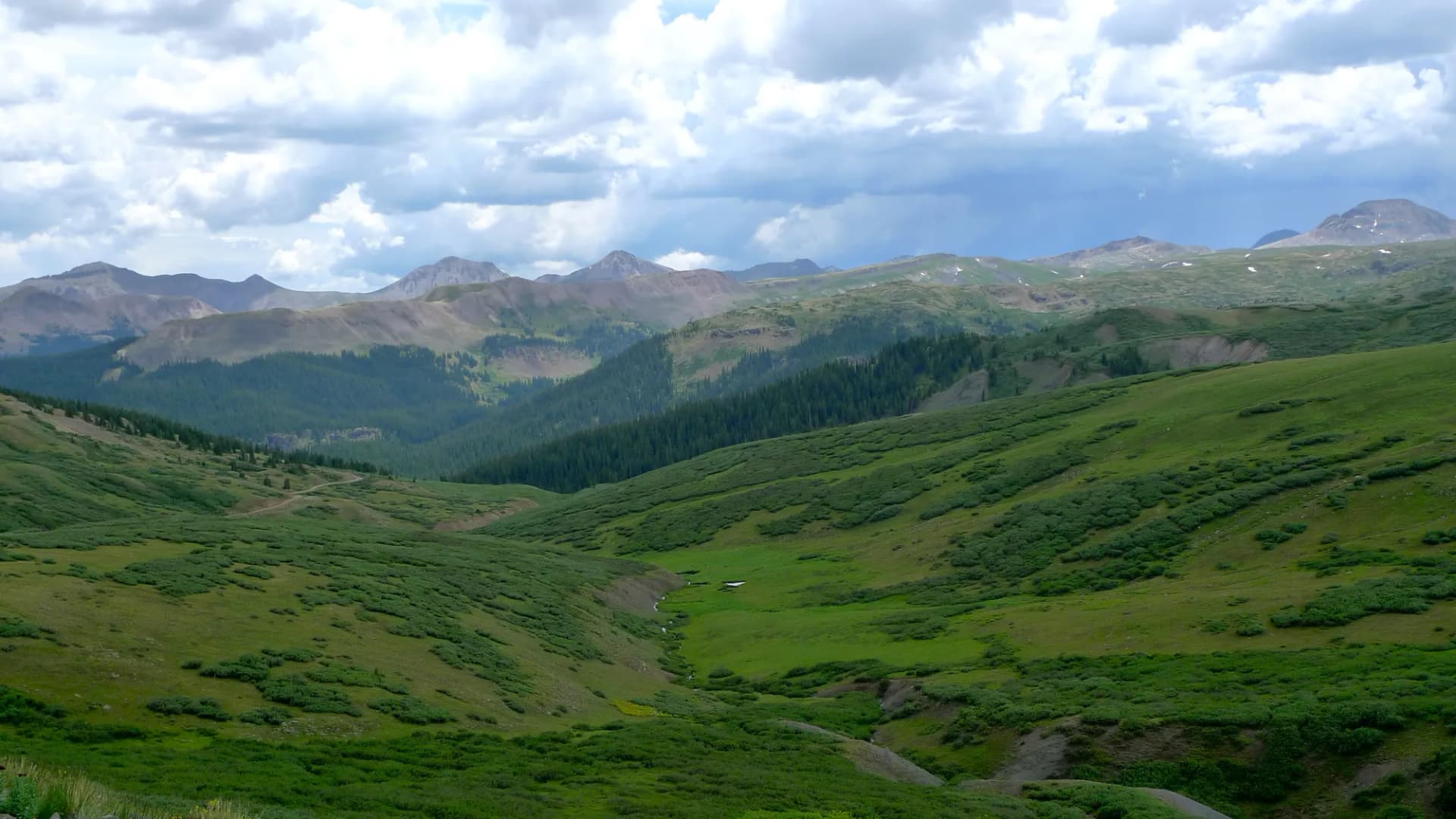 Mountain road crossing Stony Pass at 12,588 feet through rugged high-alpine terrain near the Weminuche Wilderness, Rio Grande National Forest, Colorado