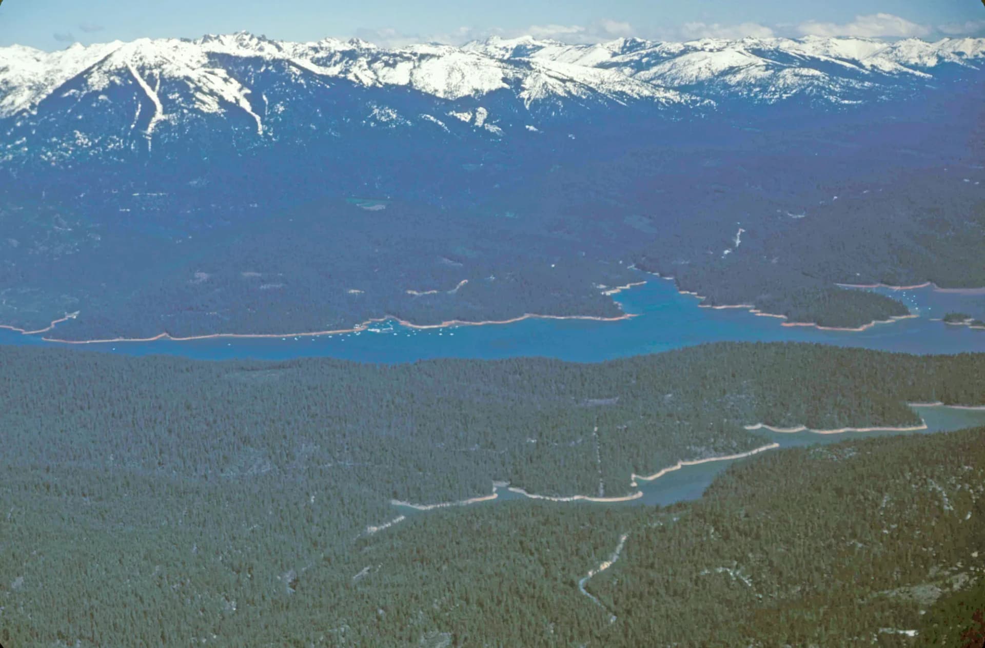 Trinity Lake reservoir surrounded by forested mountains in Shasta-Trinity National Forest, northern California